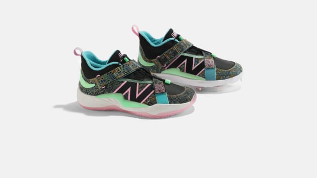 Side view of Francisco Lindor's black and pink New Balance shoes.
